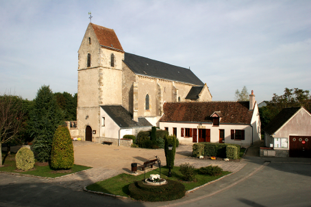A urban church next to a house, with sandstone walls 