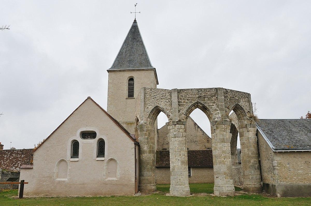 Damaged old church partially enlarged with more recent buildings. The ruins of the old archs are today visible.